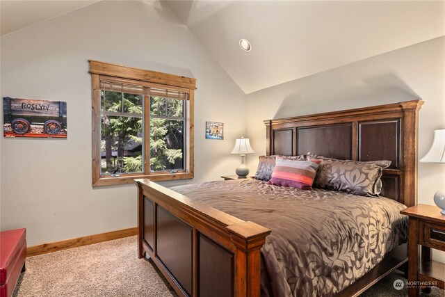 carpeted bedroom with lofted ceiling