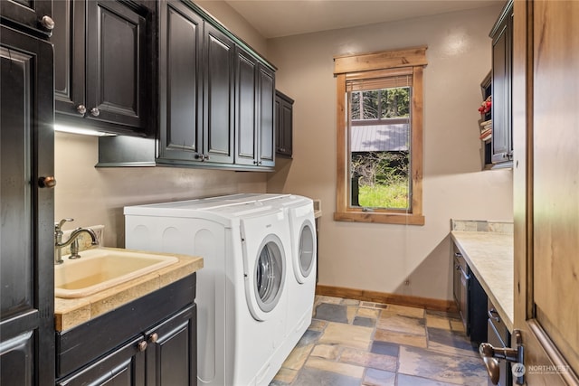 laundry area featuring sink, cabinets, and independent washer and dryer