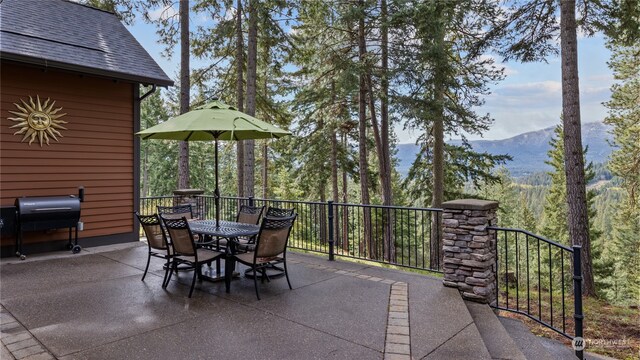 view of patio with a mountain view and a grill