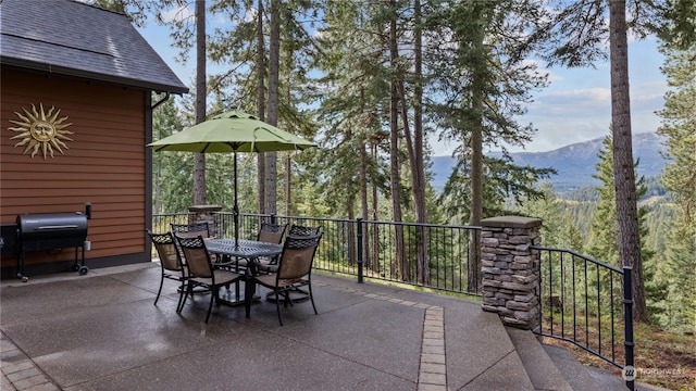1450 Pinegrass Loop, Cle Elum, WA 98922 - view of patio with outdoor dining area, a mountain view, and a grill