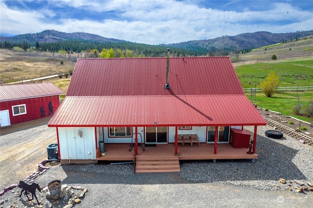 view of front of house featuring central AC unit and a deck with mountain view