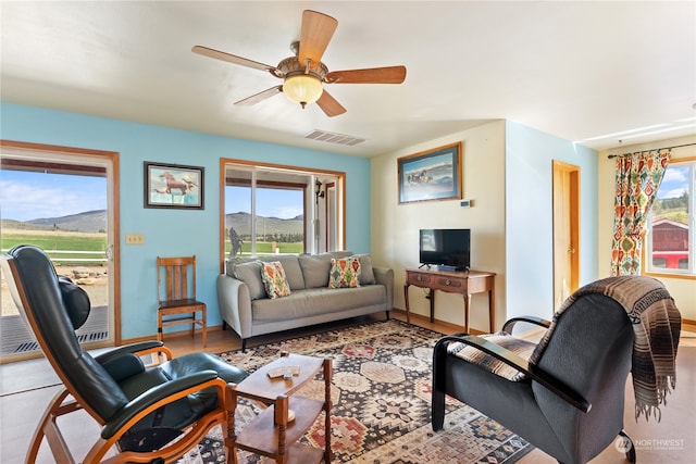 living room featuring ceiling fan and light wood-type flooring