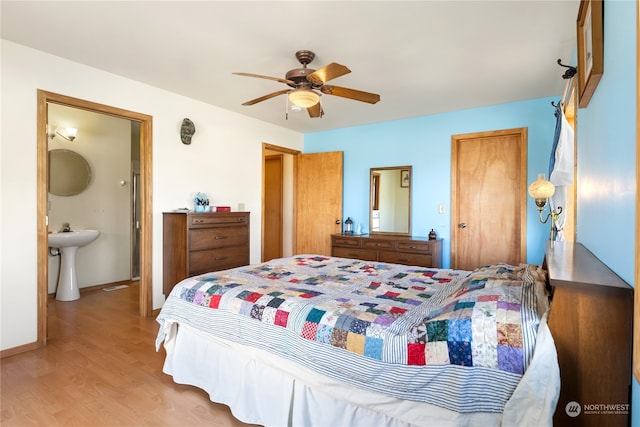 bedroom with sink, ceiling fan, light hardwood / wood-style floors, and connected bathroom