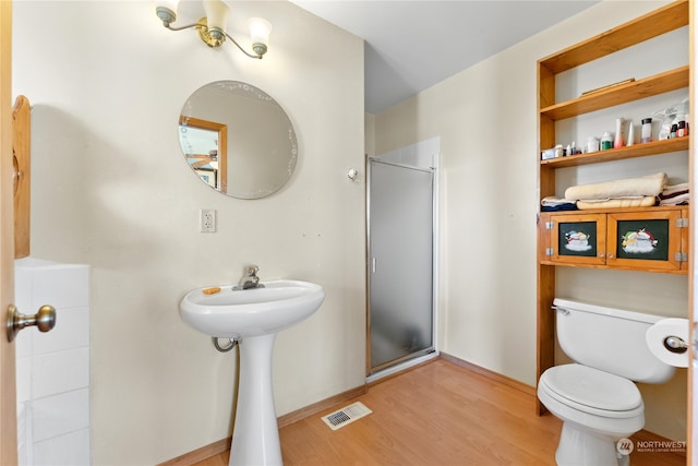 bathroom with walk in shower, hardwood / wood-style floors, and toilet