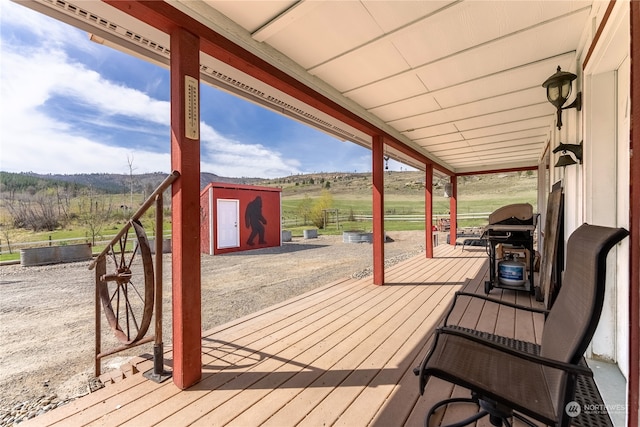 wooden terrace featuring an outdoor structure