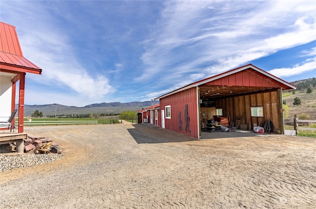 view of outdoor structure with a mountain view and a rural view