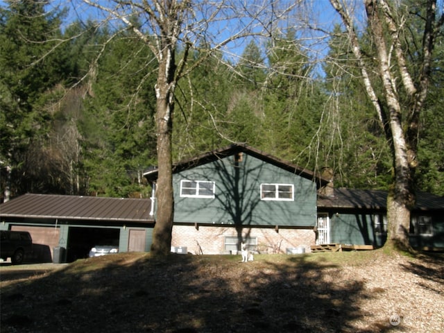 view of home's exterior with an outdoor structure