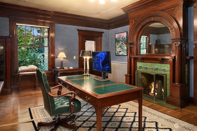 home office featuring a premium fireplace, ornamental molding, and hardwood / wood-style flooring