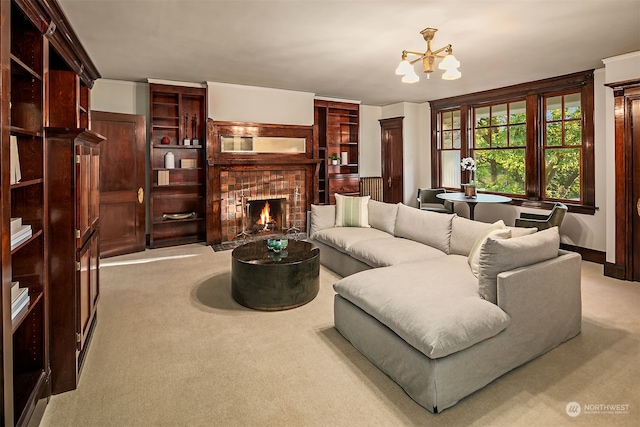 carpeted living room with a fireplace and an inviting chandelier