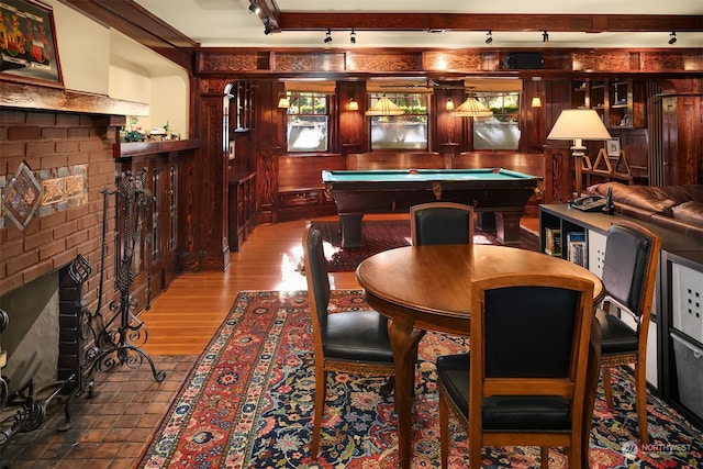 rec room with billiards, a fireplace, and hardwood / wood-style flooring