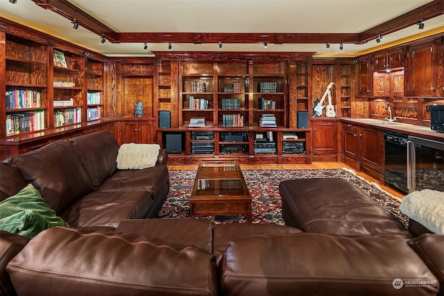 living room with beamed ceiling, sink, and wood-type flooring