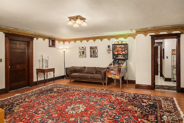 living room featuring hardwood / wood-style flooring and crown molding