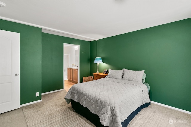 carpeted bedroom featuring ensuite bath