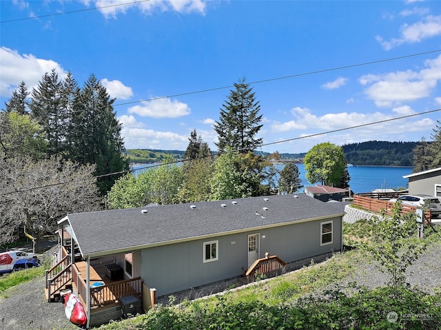 exterior space with a deck with water view