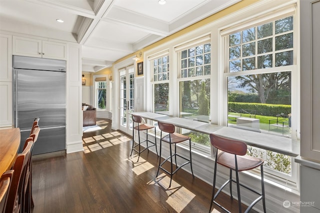 sunroom / solarium with coffered ceiling, french doors, and beam ceiling