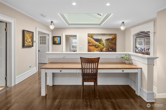 unfurnished dining area featuring crown molding, a skylight, hardwood / wood-style flooring, and built in desk