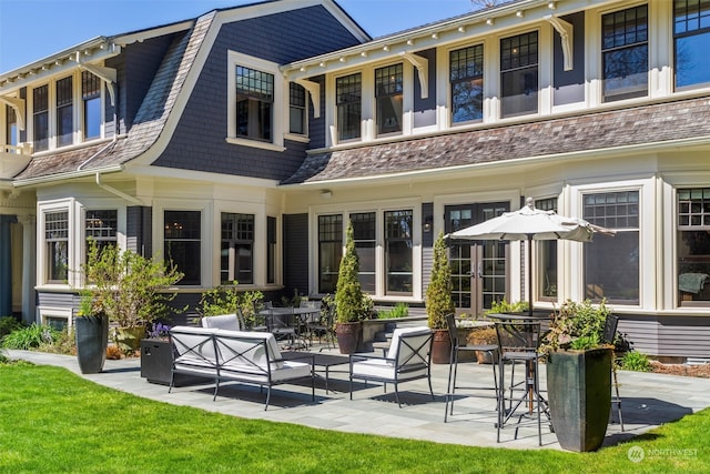 back of property featuring a yard and a patio area