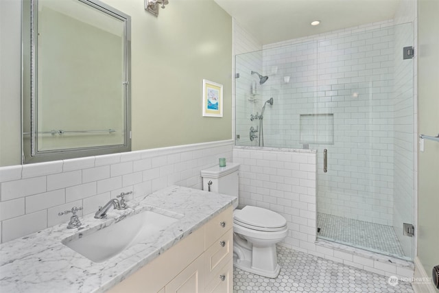 bathroom featuring vanity, toilet, an enclosed shower, tile walls, and tile patterned flooring