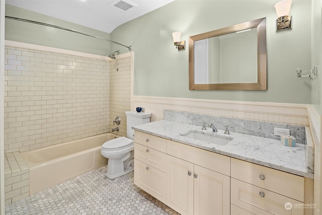 full bathroom featuring vanity, tiled shower / bath combo, toilet, and tile patterned floors