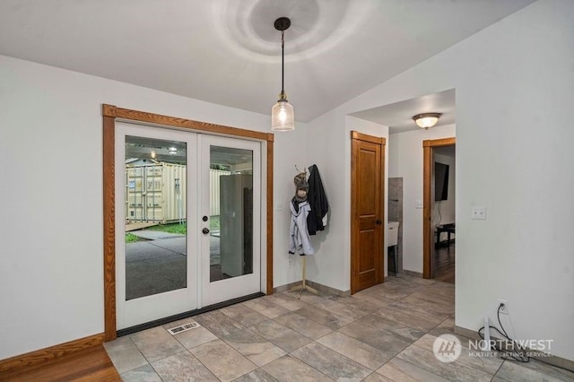 entryway with vaulted ceiling, french doors, visible vents, and baseboards