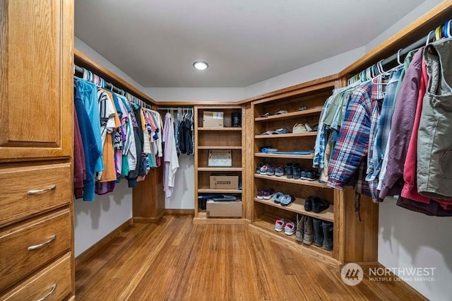 spacious closet with light hardwood / wood-style floors