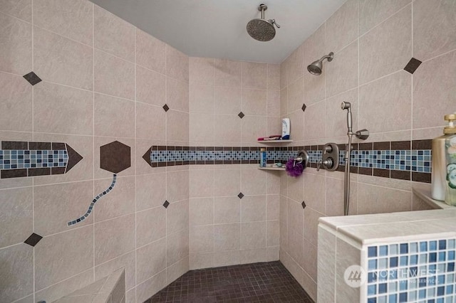 bathroom featuring a tile shower and visible vents