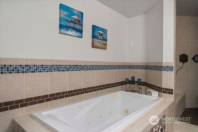 bathroom with tile walls and tiled bath