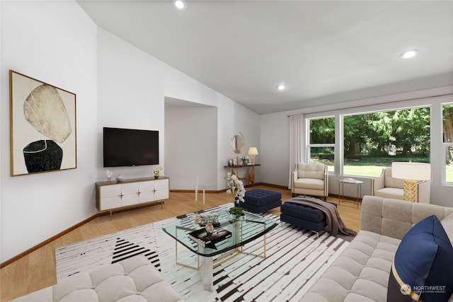 living room with light wood-type flooring and vaulted ceiling