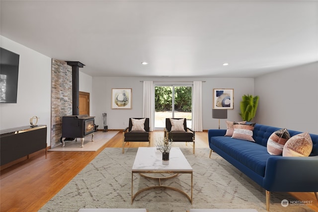 living room with light wood-type flooring and a wood stove