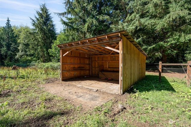 view of pole building with a carport and fence