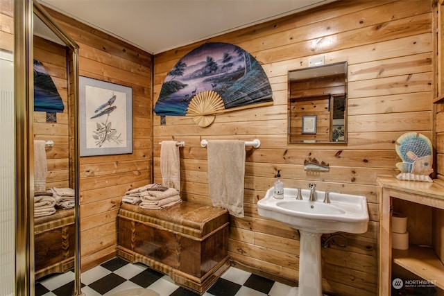 bathroom featuring wood walls