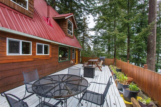 wooden terrace with an outdoor fire pit