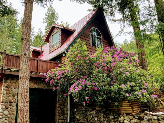 view of home's exterior featuring a wooden deck and a garage