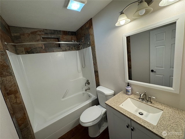 full bathroom featuring toilet, washtub / shower combination, and large vanity