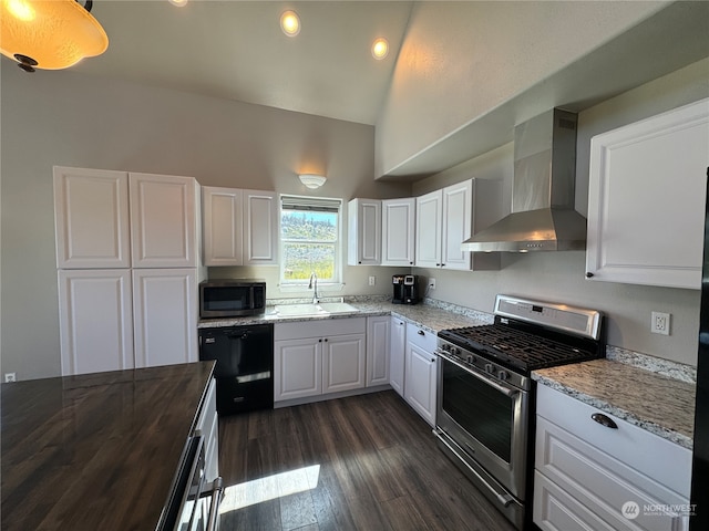 kitchen with appliances with stainless steel finishes, dark hardwood / wood-style floors, wall chimney exhaust hood, white cabinets, and sink