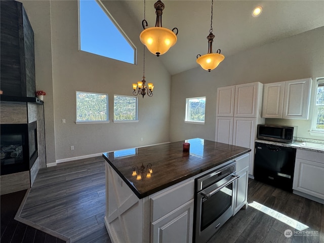 kitchen with white cabinets, a kitchen island, dark hardwood / wood-style flooring, and stainless steel appliances