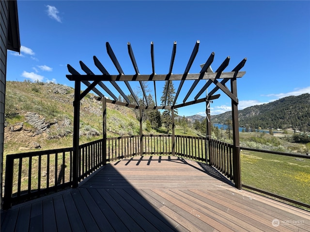 wooden deck with a mountain view and a pergola