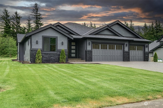 craftsman inspired home with a yard and a garage