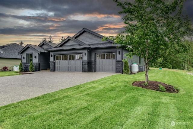 craftsman house with a garage and a yard