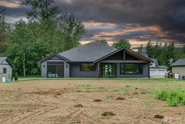 view of back house at dusk