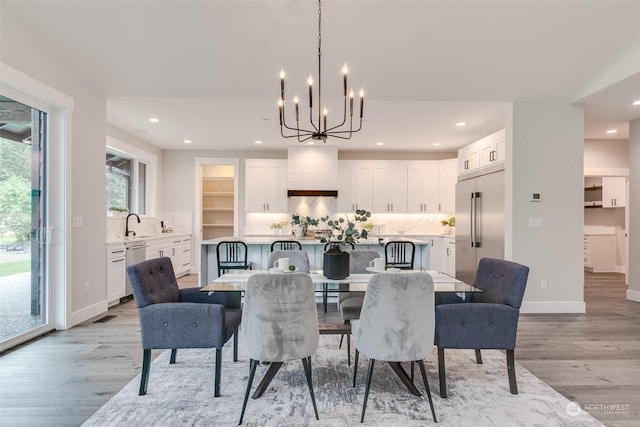 dining area with a notable chandelier and light wood-type flooring