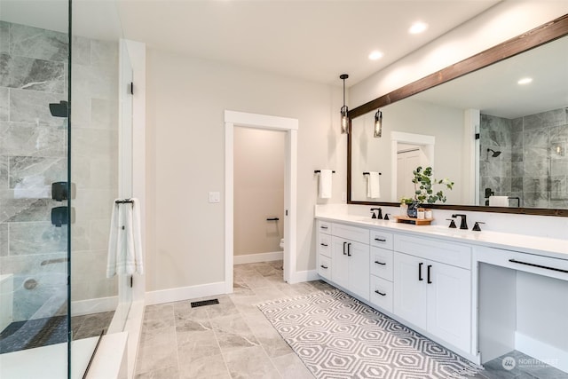 bathroom with vanity, an enclosed shower, and toilet