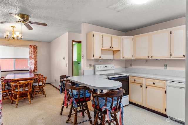 kitchen featuring ceiling fan with notable chandelier, a textured ceiling, and white appliances