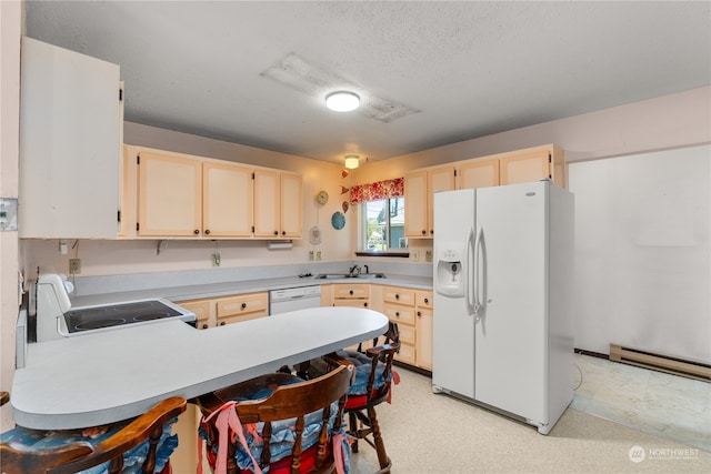 kitchen with baseboard heating, white appliances, kitchen peninsula, sink, and a breakfast bar area