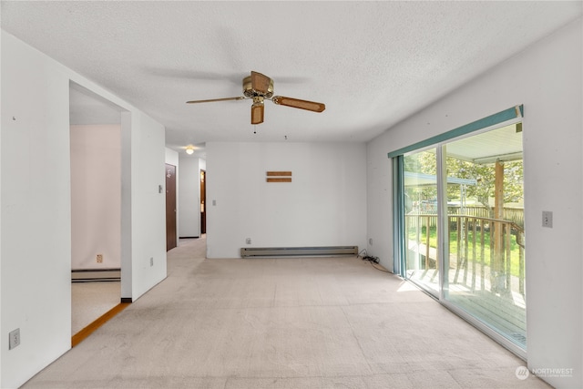 spare room featuring light colored carpet, ceiling fan, a baseboard radiator, and a textured ceiling