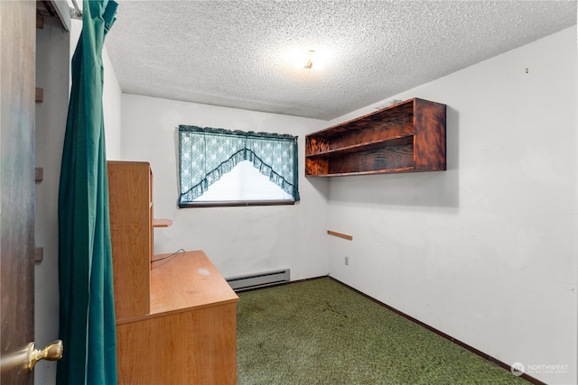 interior space with baseboard heating, carpet floors, and a textured ceiling