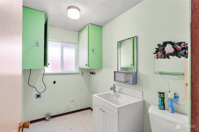 bathroom featuring vanity, toilet, and a textured ceiling