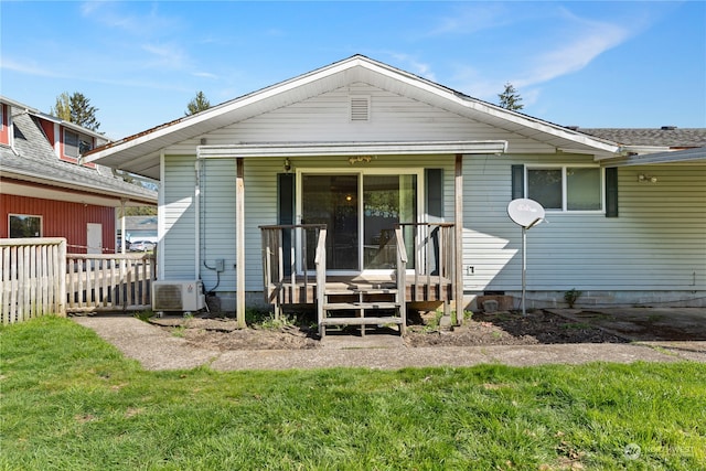 back of property with central AC and a yard