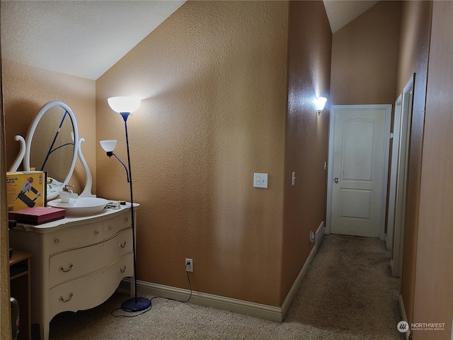 interior space with lofted ceiling and carpet