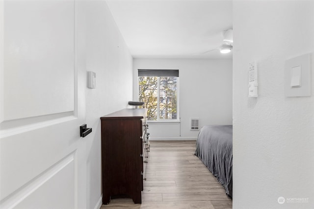 bedroom featuring light hardwood / wood-style flooring and ceiling fan